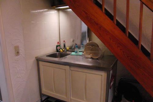 eine kleine Küche mit einem Waschbecken und einer Treppe in der Unterkunft Ferienwohnung Volskyy in Trier