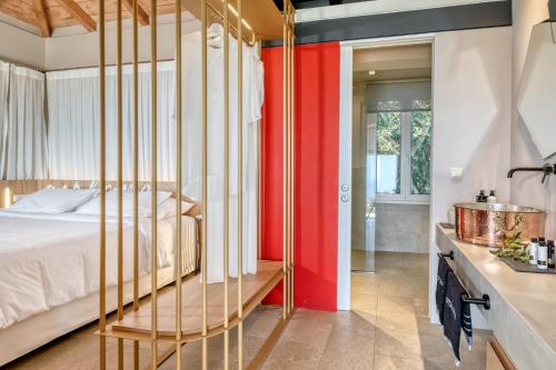 a bedroom with a bed and a red wall at Artblue Villas in Tsoukaladhes