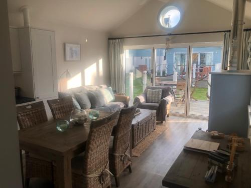 a living room with a table and a couch at Secret Of Eden Beach House in Filey