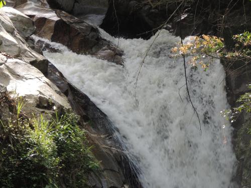 a waterfall on the side of a rocky mountain at Hostal Alto de la Montaña in Minca