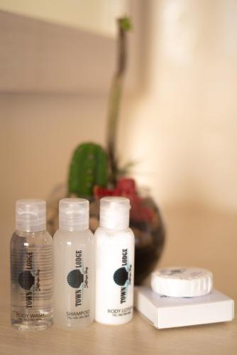 two bottles of water and a bottle of soap on a table at Grand House Lodge And SPA Jeffreys Bay in Jeffreys Bay