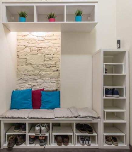 a walk in closet with blue and red pillows and shoes at The RoadHouse Prague in Prague