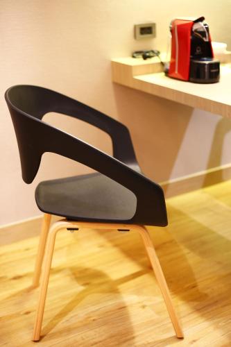 a black chair sitting in front of a counter at Montana Hotel Songkhla in Songkhla