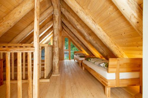 a log cabin with a bed in the attic at Ferienhof Schelchen in Hollenstein an der Ybbs