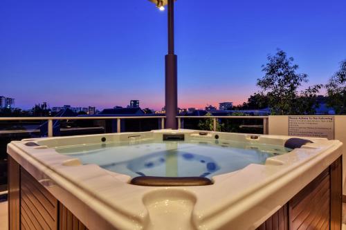 a jacuzzi tub with a view of the city at Luxury Darwin City Lights Jacuzzi Central Location Large House New Furnishings in Darwin