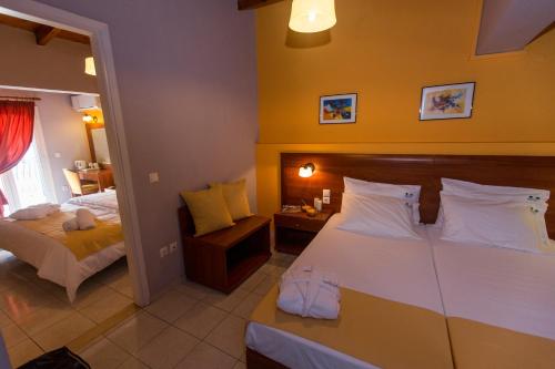 a hotel room with a bed and a bed and a mirror at Mirabel CityCenter Hotel in Argostoli