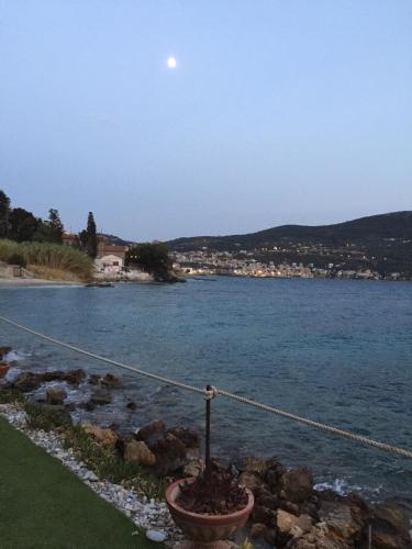 a view of a body of water with the moon in the sky at Roditses Beach Sea Front Apartments in Samos