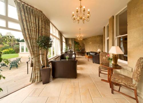 a living room with a chandelier and a lobby at Leigh Park Country House Hotel & Vineyard, BW Signature Collection in Bradford on Avon