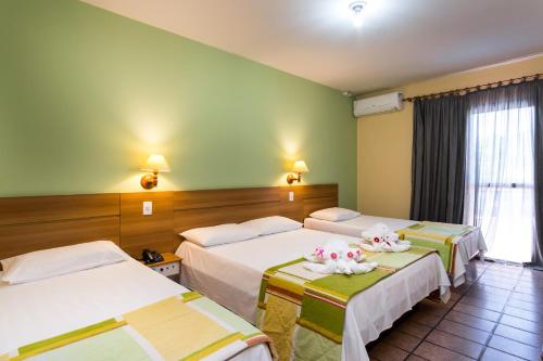 Voodi või voodid majutusasutuse Hotel Ponta das Toninhas toas