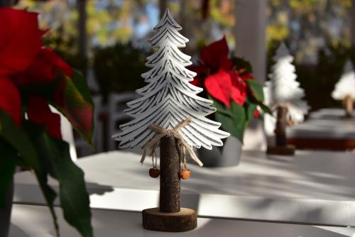 a miniature christmas tree on a table with flowers at QuodLibet in Rome