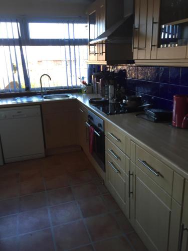 a kitchen with a sink and a stove top oven at Sturry House in Sturry