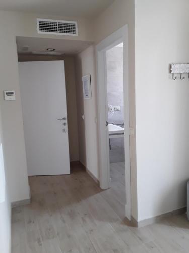 an empty room with a door and a bedroom at Punta Carnero Hostal in Algeciras