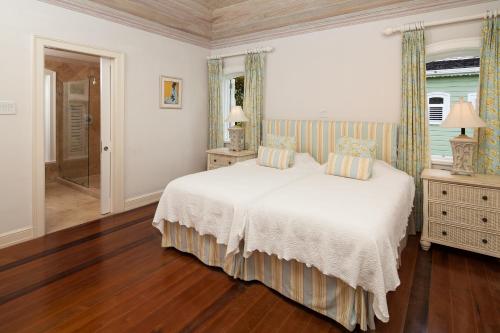 a bedroom with a white bed and a window at Little Good Harbour in Saint Peter