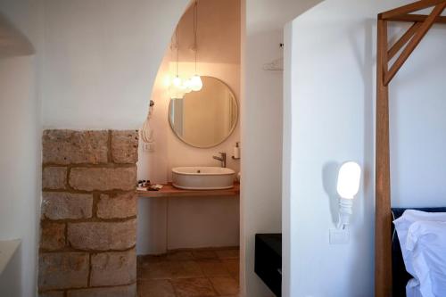 a bathroom with a sink and a mirror at Aquamarea in Polignano a Mare