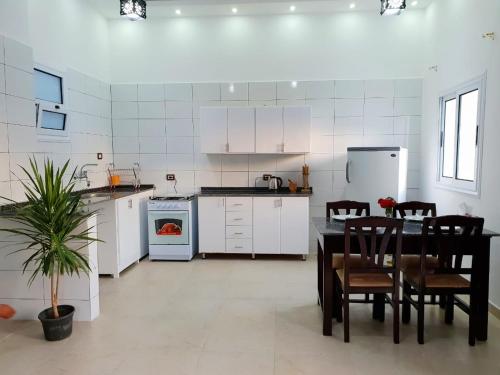 a kitchen with a table and chairs and a stove at Marhaba Guest House in Luxor