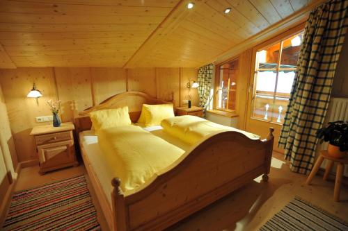 a bedroom with a large bed in a room at Biobauernhof Fleckl in Hopfgarten im Brixental