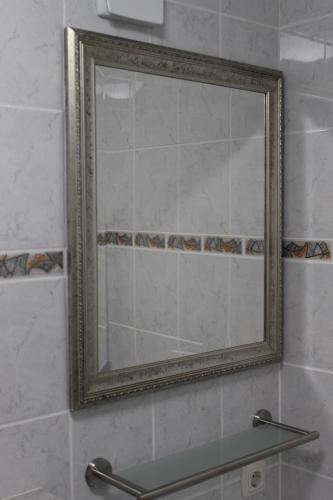 a mirror on a wall in a bathroom at Tolles Appartement mit Klima, Garage für's Auto, Bike's und Skier in Sankt Englmar