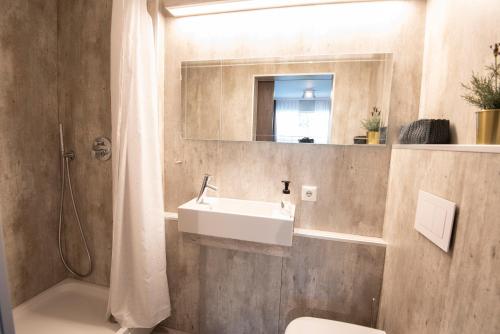 a bathroom with a sink and a mirror at Gardabær Sea View Apartment in Garðabær