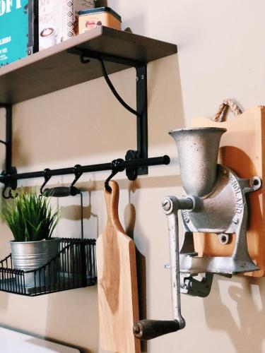 a kitchen shelf with a mortar and pestle on a wall at Argya Guesthouse in Yogyakarta
