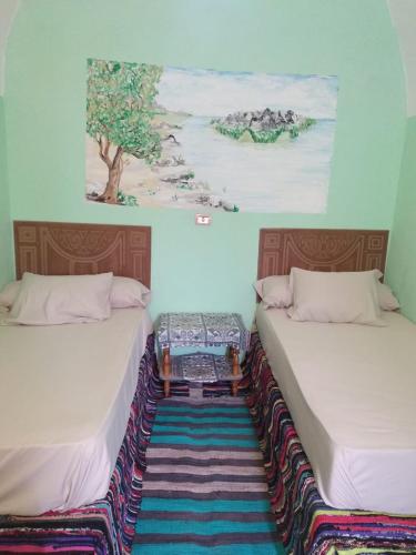 Кровать или кровати в номере Aswan Nubian House