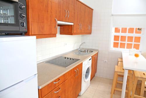 a small kitchen with a sink and a dishwasher at Vivienda Vacacional Camino del Senderista in Lodero