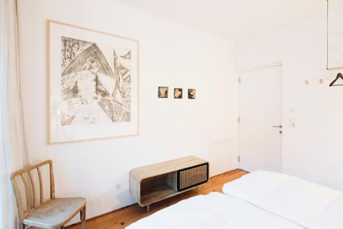 a bedroom with a bed and a tv and a chair at Ferienhaus Wenefrieda in Schoppernau