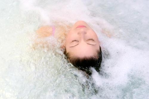 a man laying on his back in the water at Bagińscy Spa in Pobierowo