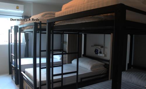 a group of bunk beds in a room at Phuket Marine Poshtel - SHA Plus in Chalong 