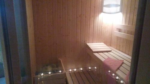 a small bathroom with a tub and a light at APARTMAN SAUNA "NINO" in Gornje Jesenje