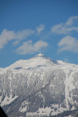 a mountain with a cross on top of it at Pension Ederhof in Jochberg