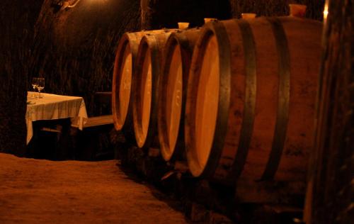 a row of wine barrels sitting next to a table at Myrtus Pince és Vendégház in Tarcal