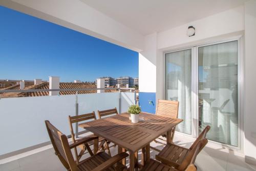 a dining room with a table and chairs on a balcony at El Mirador De Villamartin - La Zenia & Golf in Playas de Orihuela