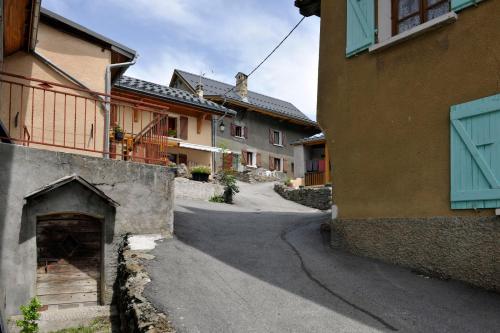 an empty street in a village with buildings at Camping RCN Belledonne in Le Bourg-dʼOisans