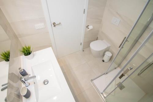 a white bathroom with a shower and a toilet at El Mirador De Villamartin - La Zenia & Golf in Playas de Orihuela