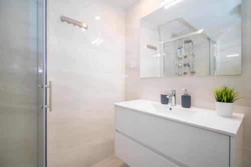 a white bathroom with a sink and a shower at El Mirador De Villamartin - La Zenia & Golf in Playas de Orihuela