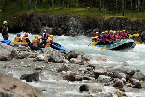 a group of people in rafts in a river at Camping RCN Belledonne in Le Bourg-dʼOisans