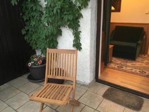 a wooden chair sitting in front of a door at Antik Hotel Sofia in Litomyšl