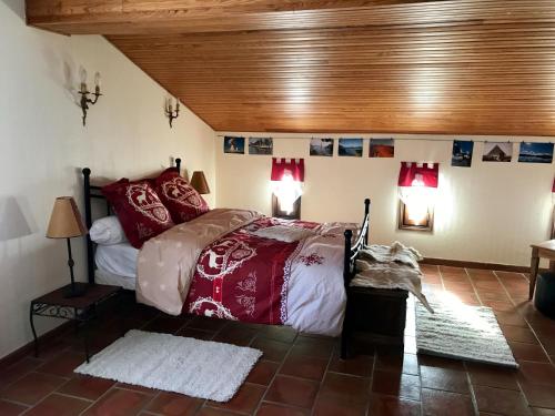 Un dormitorio con una cama con almohadas rojas. en Chambre d'Hôtes Casa Mia en Belvédère