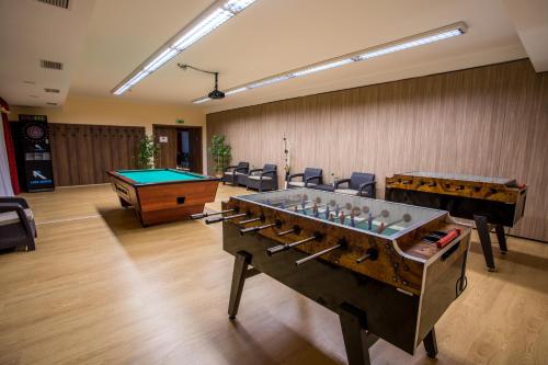 a room with a pool table and ping pong balls at Luxury Hotel Siófok in Siófok