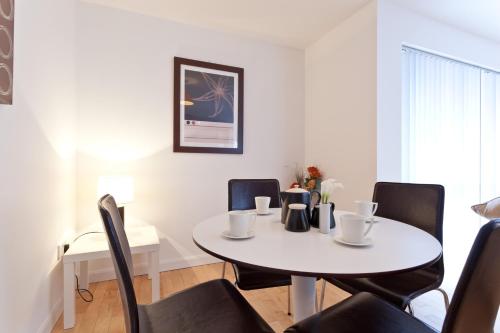 a dining room with a white table and chairs at 6a Cedar Grove in Bangor