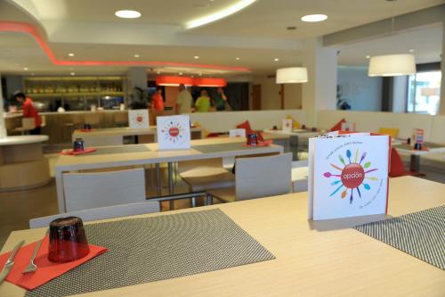 a restaurant with a table with a sign on it at Ibis Cornella in Cornellà de Llobregat