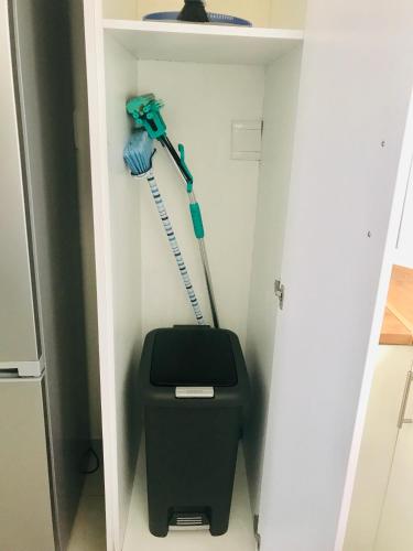 a bathroom with a mop and a trash can at Bismarck 2 in Swakopmund