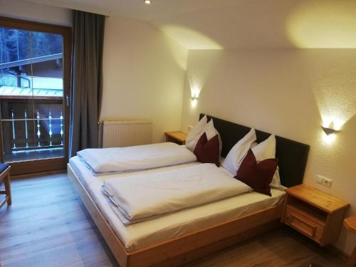 a bedroom with a bed in a room with a window at Haus Wimmer in Saalbach-Hinterglemm