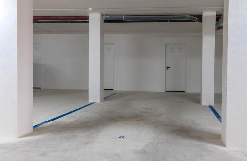 an empty room with white walls and white columns at El Mirador De Villamartin - La Zenia & Golf in Playas de Orihuela