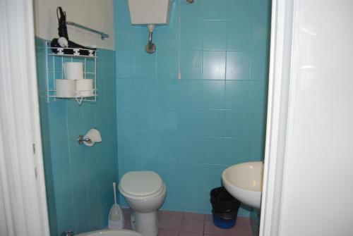 a blue bathroom with a toilet and a sink at Soggiorno Santa Reparata in Florence