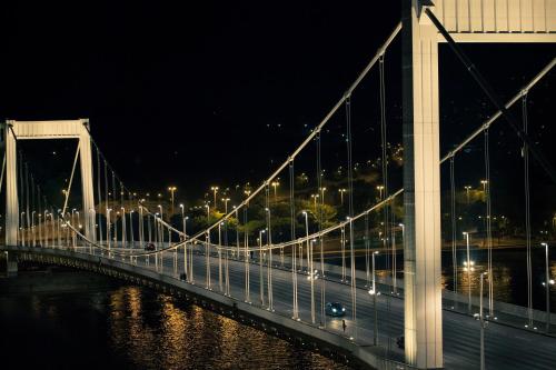 a bridge over a river at night with lights at City Hotel Matyas in Budapest