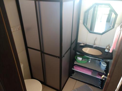 a bathroom with a sink and a mirror at Apartamentos Di Armazzem in Torres