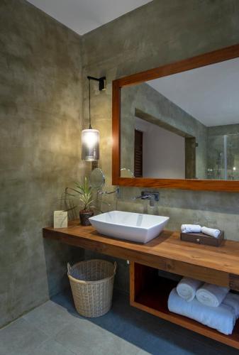 a bathroom with a sink and a mirror at Ayana Sea in Wadduwa
