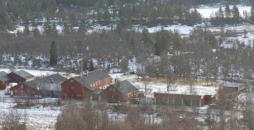 a group of houses in a field with snow at Vats Fjellstue in Ål