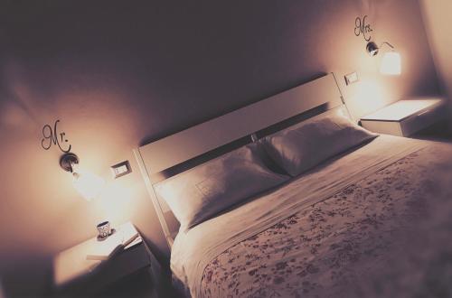 a bedroom with a large bed with two lights on it at Sweet Holiday Home in Bernalda